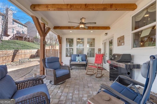 view of patio with fence, an outdoor living space, and a ceiling fan