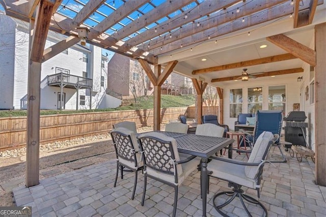 view of patio with outdoor dining area, grilling area, fence, and a pergola