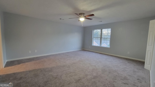 unfurnished room with ceiling fan, baseboards, and carpet flooring