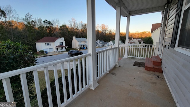 balcony featuring covered porch and a residential view