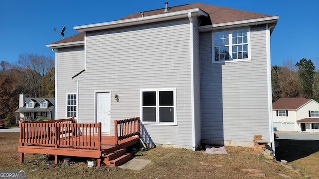 back of house with a deck and a shingled roof