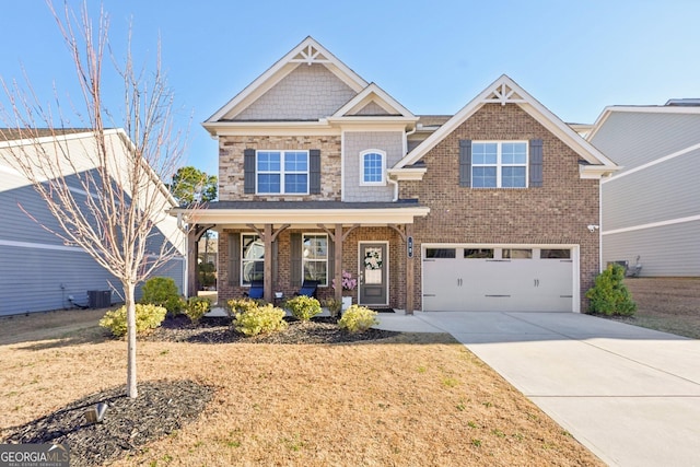 craftsman house featuring driveway, a porch, an attached garage, and a front yard