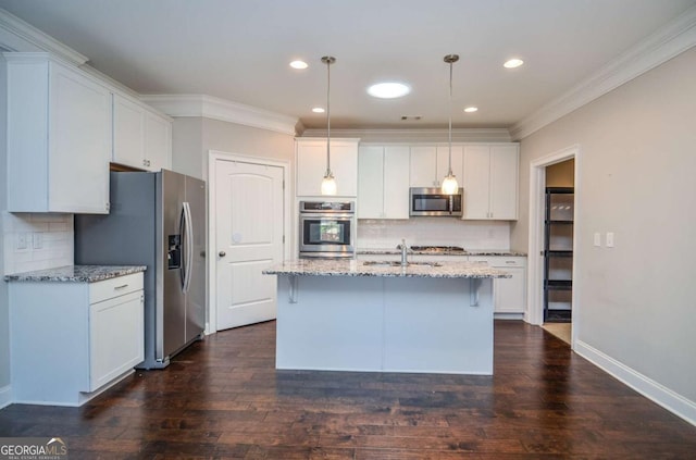 kitchen featuring dark wood-style flooring, crown molding, appliances with stainless steel finishes, white cabinetry, and light stone countertops