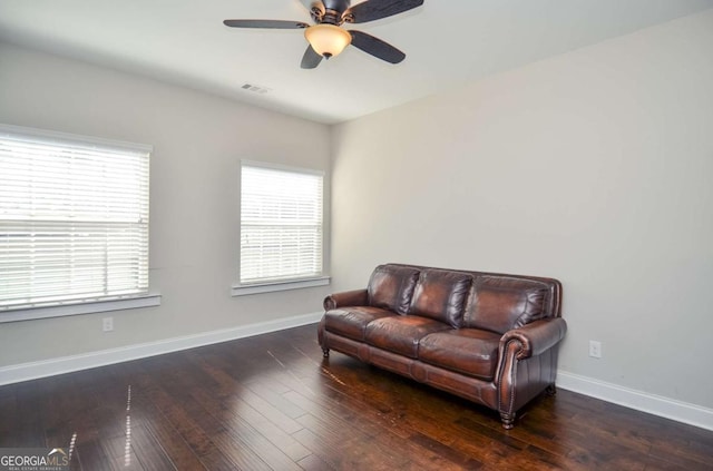 sitting room with hardwood / wood-style flooring, plenty of natural light, visible vents, and baseboards