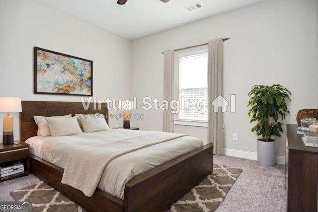 bedroom featuring light carpet, a ceiling fan, visible vents, and baseboards