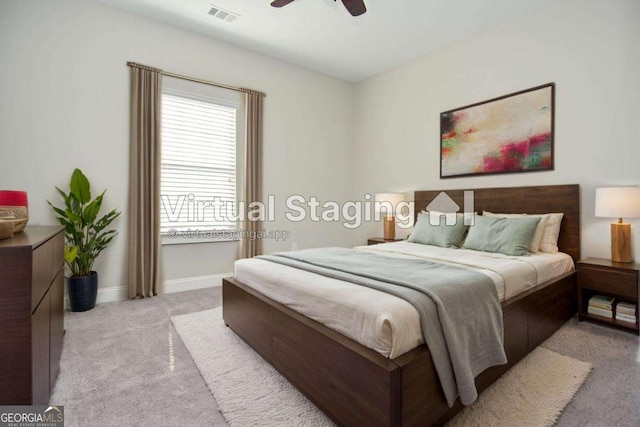 bedroom with baseboards, ceiling fan, visible vents, and light colored carpet