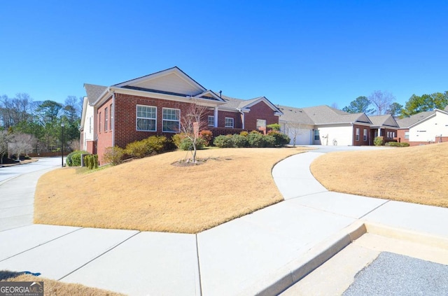 single story home with brick siding and a front lawn