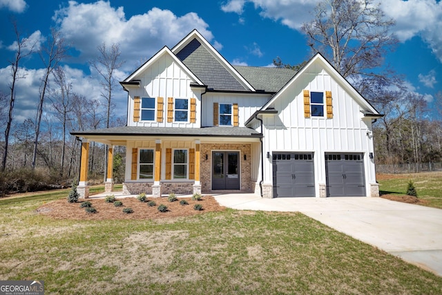 modern farmhouse with a garage, concrete driveway, covered porch, board and batten siding, and a front yard