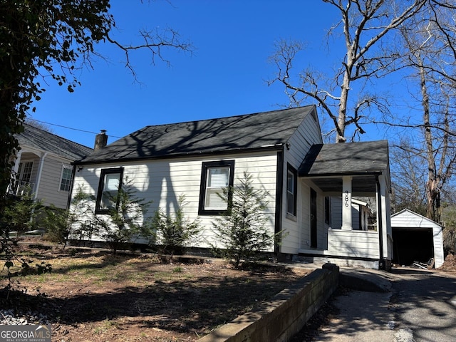 view of front of house featuring an outbuilding and a detached garage