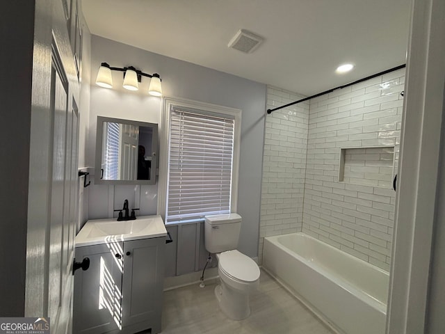 bathroom with toilet, shower / bath combination, visible vents, and vanity