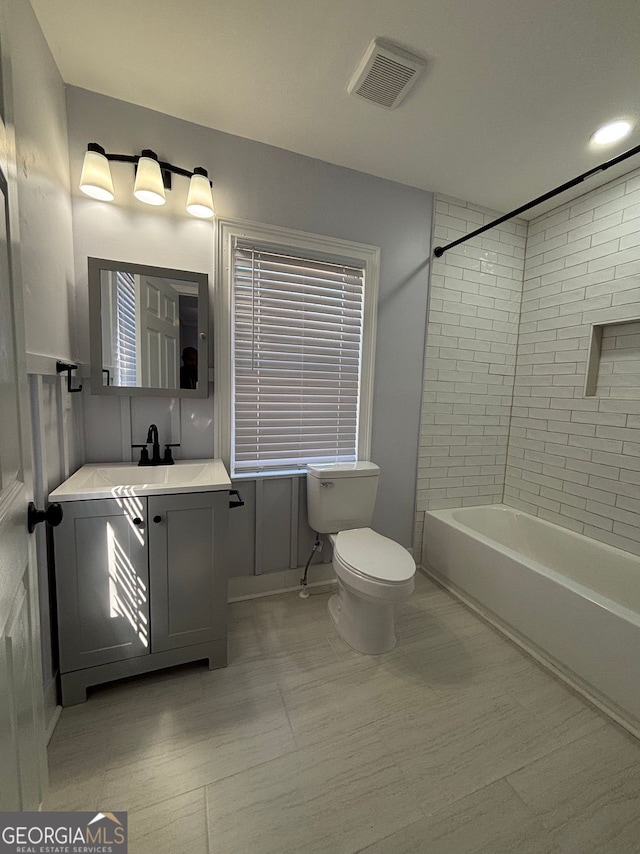 full bath featuring shower / bath combination, visible vents, vanity, and toilet