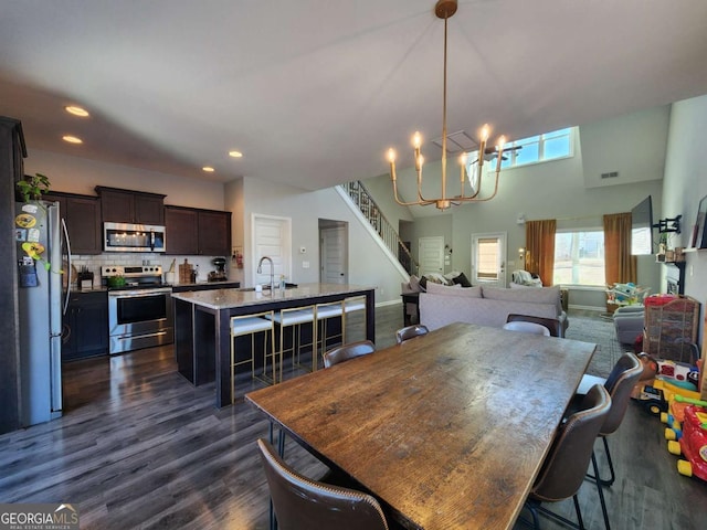 dining space featuring visible vents, stairway, dark wood-type flooring, a chandelier, and recessed lighting