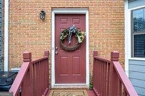 property entrance featuring brick siding