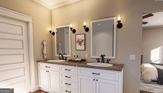 ensuite bathroom featuring ensuite bathroom, double vanity, ornamental molding, and a sink