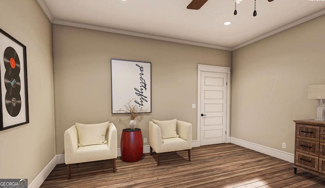 living area with ceiling fan, baseboards, and crown molding