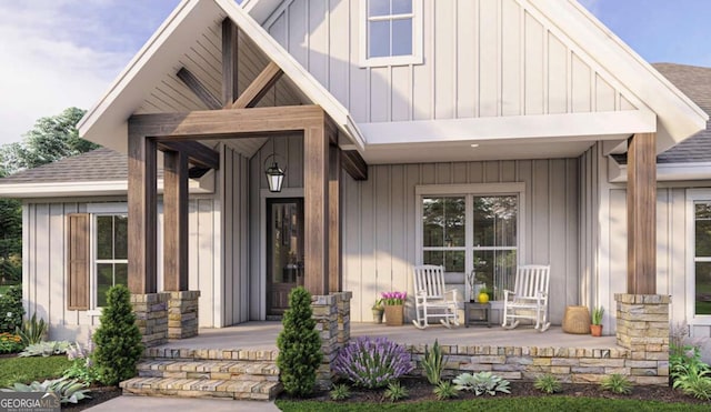 doorway to property with covered porch, a shingled roof, and board and batten siding