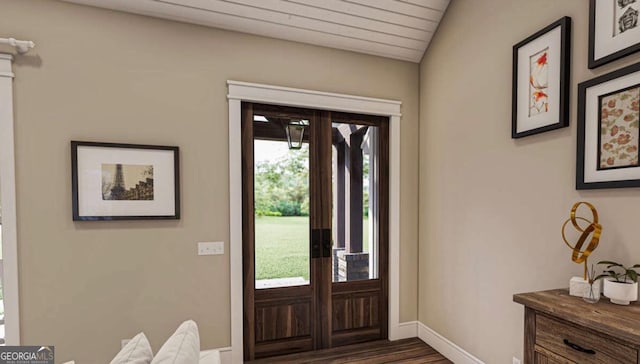 foyer with french doors, baseboards, and wood finished floors