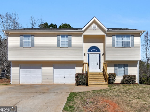 bi-level home with driveway and an attached garage