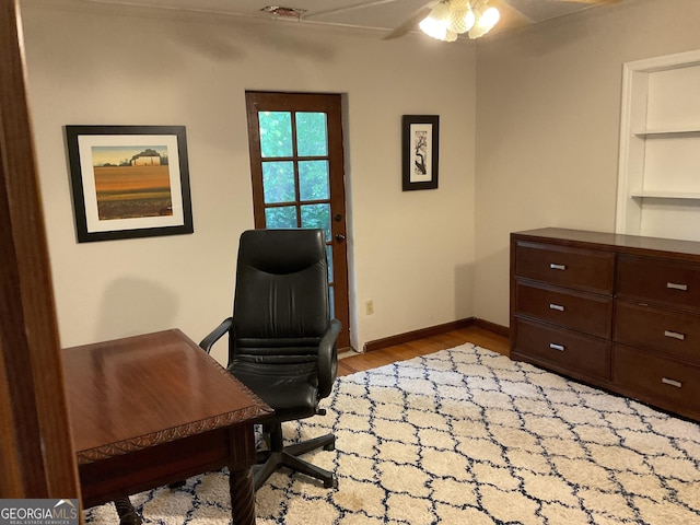 office space featuring baseboards, a ceiling fan, and wood finished floors