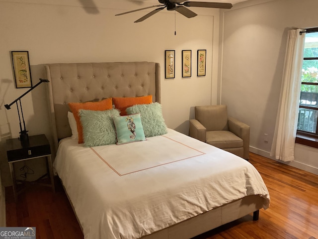 bedroom featuring baseboards, a ceiling fan, and wood finished floors