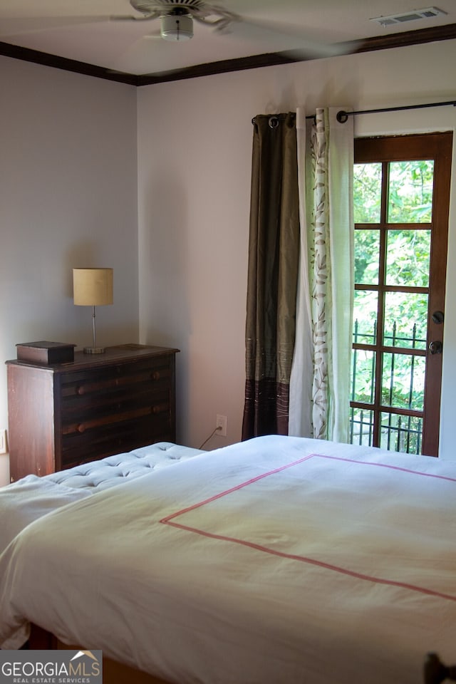 bedroom with visible vents and crown molding