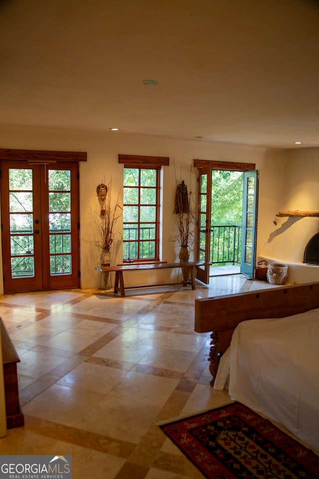bedroom featuring french doors, access to exterior, and multiple windows
