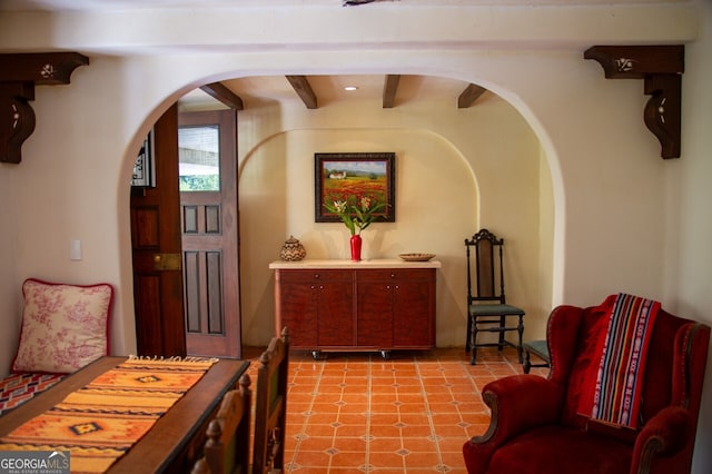 living area featuring arched walkways and light floors