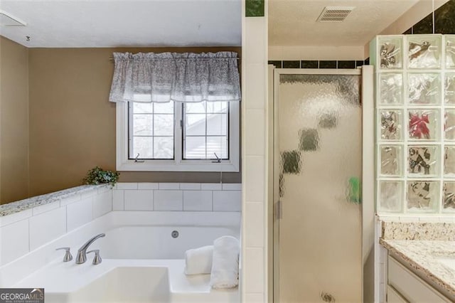 full bath featuring a stall shower, visible vents, a bath, and vanity