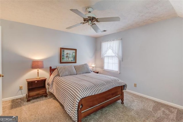 bedroom with carpet, baseboards, ceiling fan, and a textured ceiling