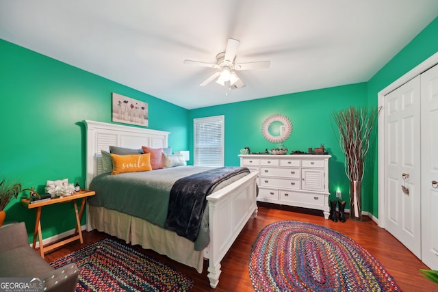 bedroom featuring a closet, dark wood-style flooring, ceiling fan, and baseboards