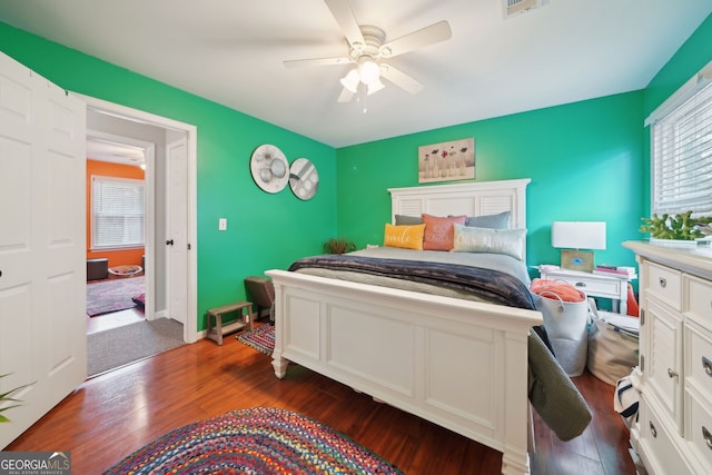 bedroom with a ceiling fan, baseboards, and wood finished floors