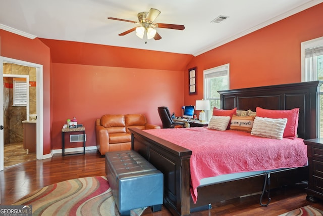 bedroom with baseboards, visible vents, ornamental molding, wood finished floors, and vaulted ceiling