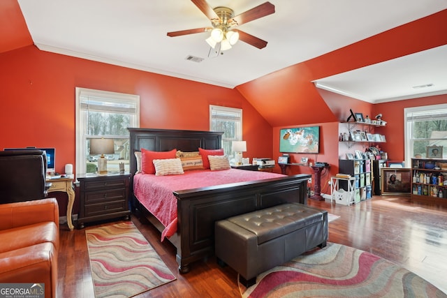 bedroom featuring lofted ceiling, wood finished floors, and visible vents