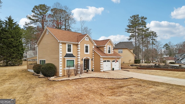 traditional-style house featuring a front yard and driveway