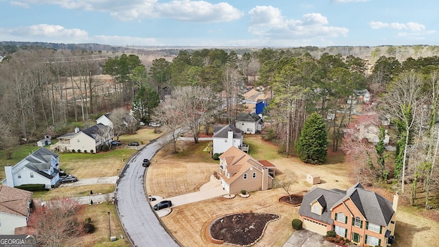 aerial view featuring a residential view and a wooded view