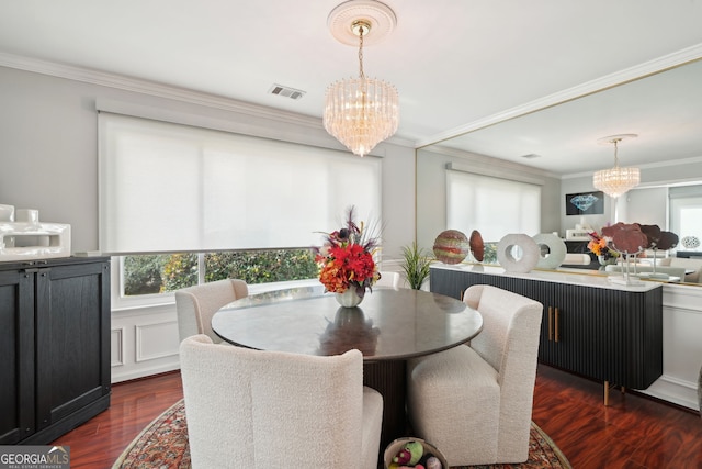 dining area featuring plenty of natural light, visible vents, a notable chandelier, and ornamental molding