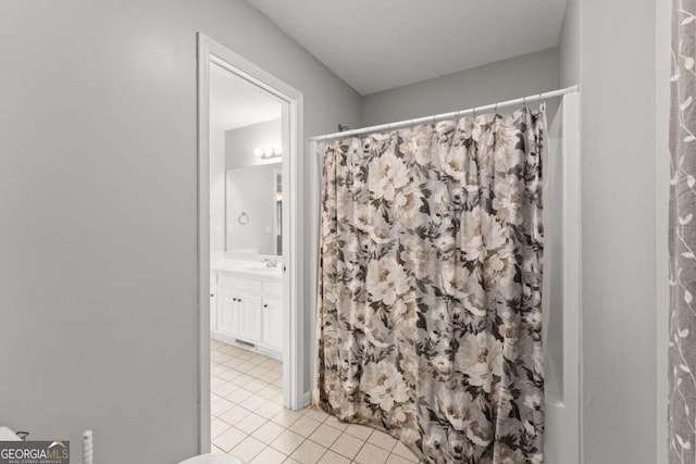 bathroom featuring a shower with shower curtain, tile patterned flooring, and vanity