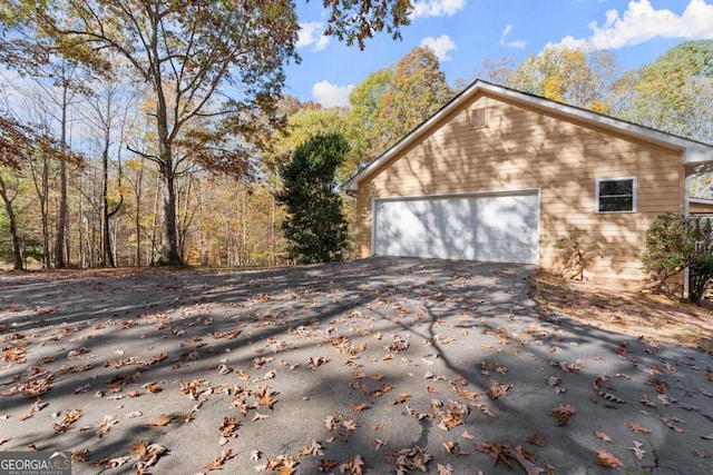 view of side of home featuring a garage