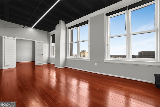 empty room featuring baseboards and wood finished floors