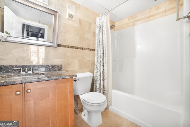 full bath with visible vents, toilet, tile patterned flooring, vanity, and tile walls