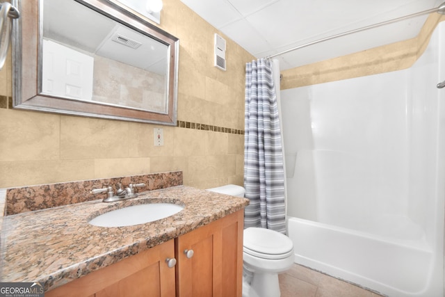 full bath with toilet, visible vents, vanity, tile walls, and tile patterned floors