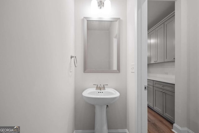 bathroom featuring baseboards and wood finished floors