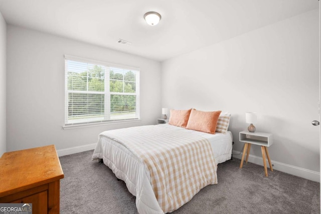 carpeted bedroom featuring visible vents and baseboards