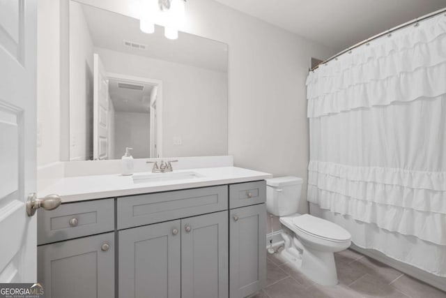 bathroom featuring toilet, tile patterned floors, visible vents, and vanity