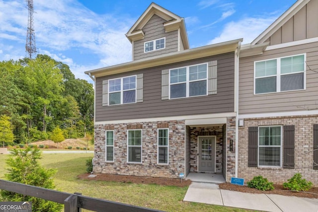 view of front of property featuring board and batten siding and a front lawn