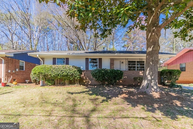 single story home with a front yard and brick siding