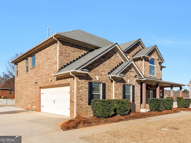 view of front of home featuring concrete driveway, brick siding, roof with shingles, and an attached garage