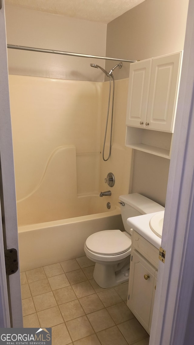 bathroom with washtub / shower combination, vanity, toilet, and tile patterned floors