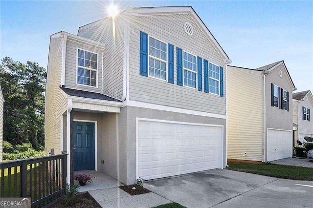 view of front of property with a garage, concrete driveway, and stucco siding