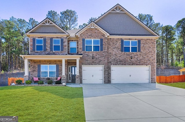 craftsman inspired home featuring driveway, a garage, fence, a front lawn, and brick siding